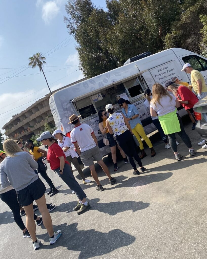 People queuing at white food truck